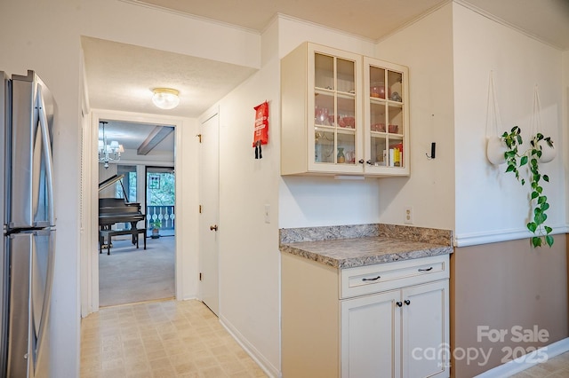 interior space featuring baseboards, freestanding refrigerator, and light carpet