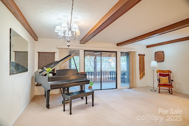 sitting room featuring a textured ceiling, baseboards, beamed ceiling, a notable chandelier, and carpet flooring