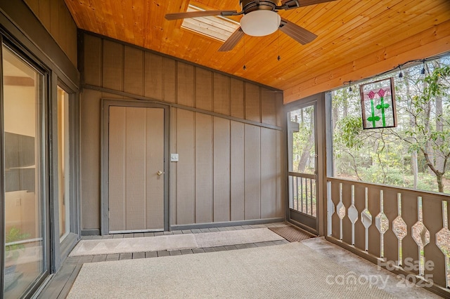 unfurnished sunroom featuring ceiling fan