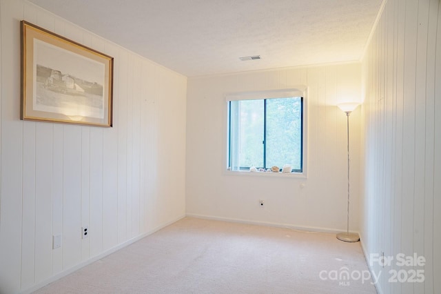 unfurnished room featuring baseboards, carpet flooring, and visible vents