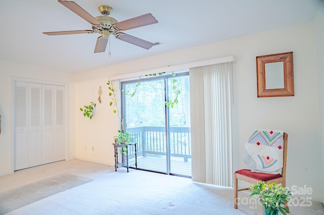 interior space with carpet floors, ceiling fan, a closet, and access to exterior