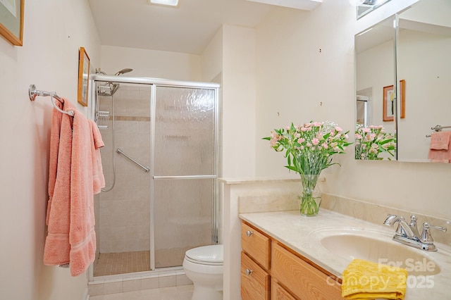 full bathroom with vanity, tile patterned floors, a stall shower, and toilet