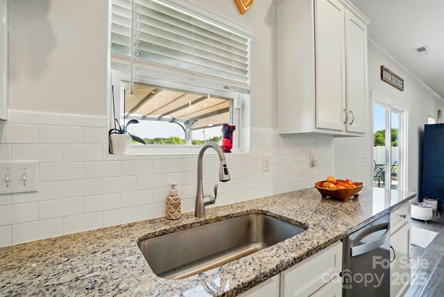 4321 Hornyak Dr, Monroe, NC 28110 - kitchen featuring a sink, white cabinets, stainless steel dishwasher, light stone counters, and ornamental molding