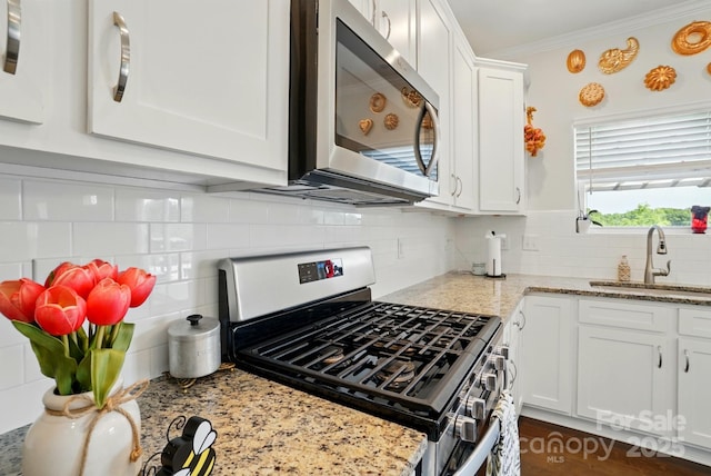4321 Hornyak Dr, Monroe, NC 28110 - kitchen with stainless steel appliances, a sink, tasteful backsplash, white cabinetry, and light stone countertops