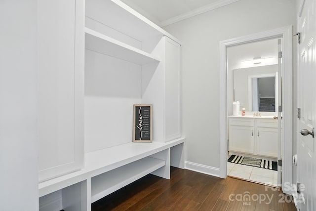 4321 Hornyak Dr, Monroe, NC 28110 - mudroom with dark wood finished floors, crown molding, baseboards, and a sink