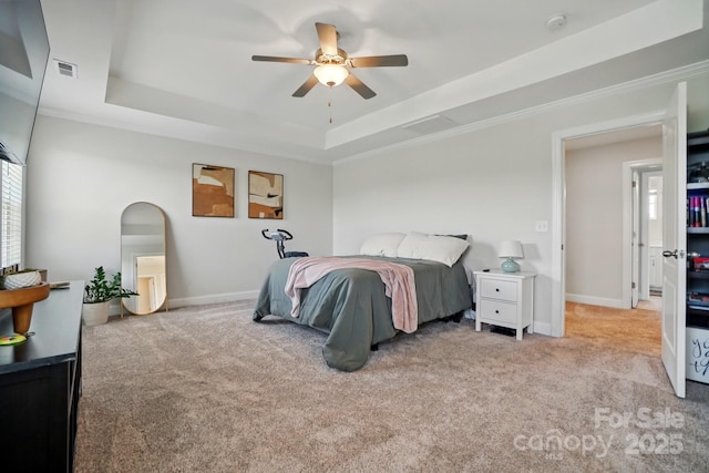 4321 Hornyak Dr, Monroe, NC 28110 - bedroom featuring a tray ceiling, carpet flooring, baseboards, ornamental molding, and ceiling fan