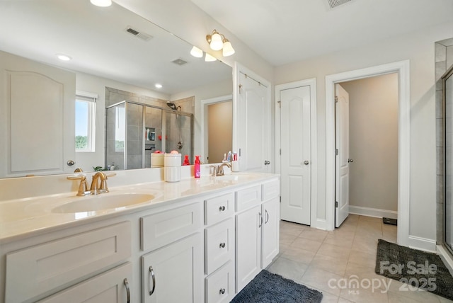 4321 Hornyak Dr, Monroe, NC 28110 - full bath featuring a stall shower, double vanity, tile patterned floors, recessed lighting, and a closet