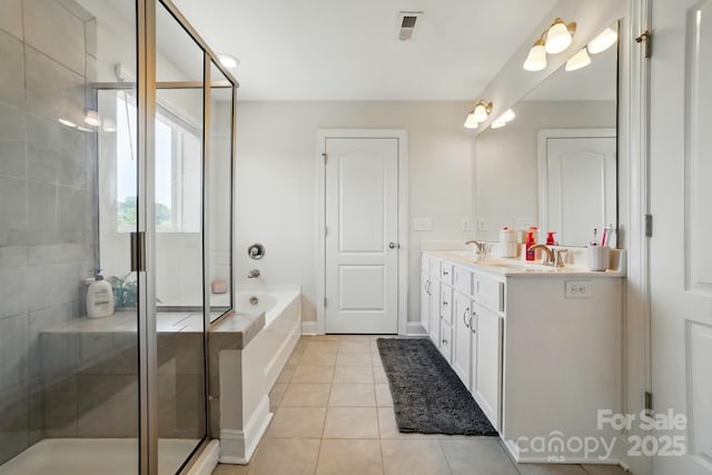 4321 Hornyak Dr, Monroe, NC 28110 - bathroom featuring double vanity, a garden tub, a stall shower, and tile patterned floors