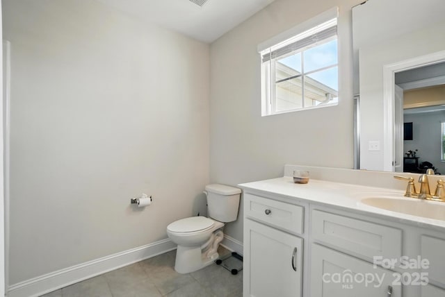 4321 Hornyak Dr, Monroe, NC 28110 - bathroom featuring toilet, vanity, tile patterned flooring, baseboards, and healthy amount of natural light