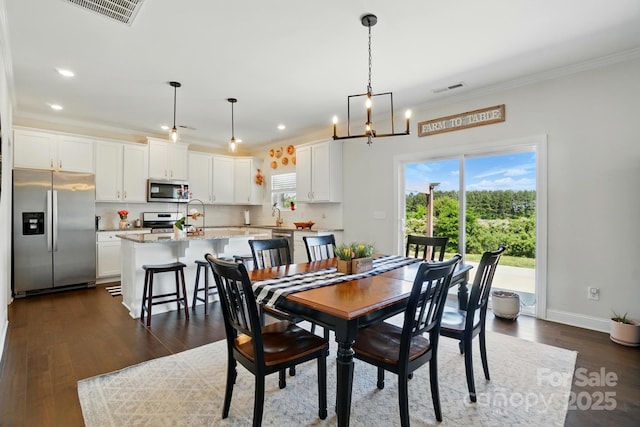 4321 Hornyak Dr, Monroe, NC 28110 - dining room featuring ornamental molding, recessed lighting, dark wood-style flooring, baseboards, and a chandelier