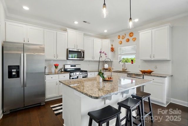4321 Hornyak Dr, Monroe, NC 28110 - kitchen featuring appliances with stainless steel finishes, a sink, white cabinetry, crown molding, and recessed lighting
