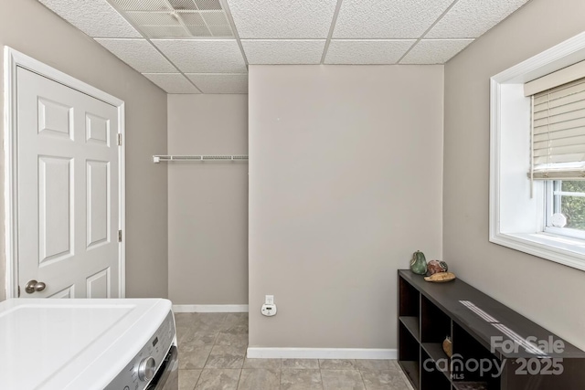 bedroom with visible vents, a paneled ceiling, baseboards, and washer / dryer