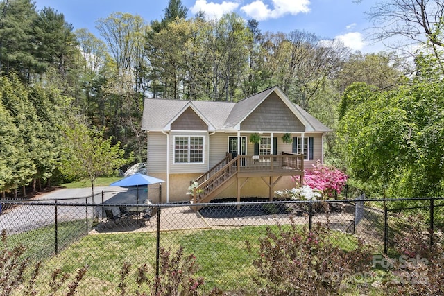 ranch-style house with stairway, a fenced backyard, a front lawn, and covered porch