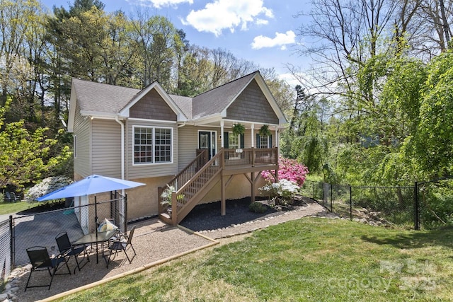 back of property featuring a porch, a lawn, a fenced backyard, and stairway