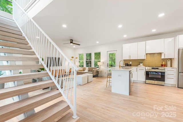 1847 Vinton St, Charlotte, NC 28216 - kitchen featuring stainless steel appliances, a kitchen breakfast bar, open floor plan, recessed lighting, and light countertops