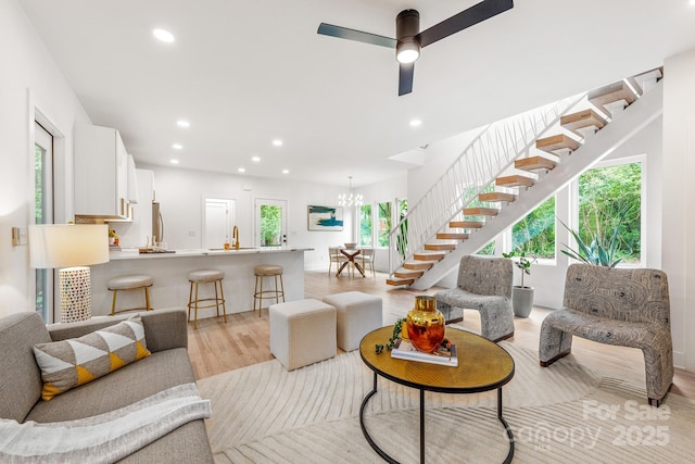 1847 Vinton St, Charlotte, NC 28216 - living room with light wood finished floors, plenty of natural light, recessed lighting, and stairway