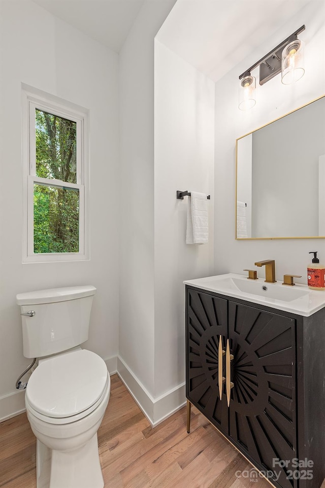 1847 Vinton St, Charlotte, NC 28216 - half bathroom featuring baseboards, toilet, and wood finished floors