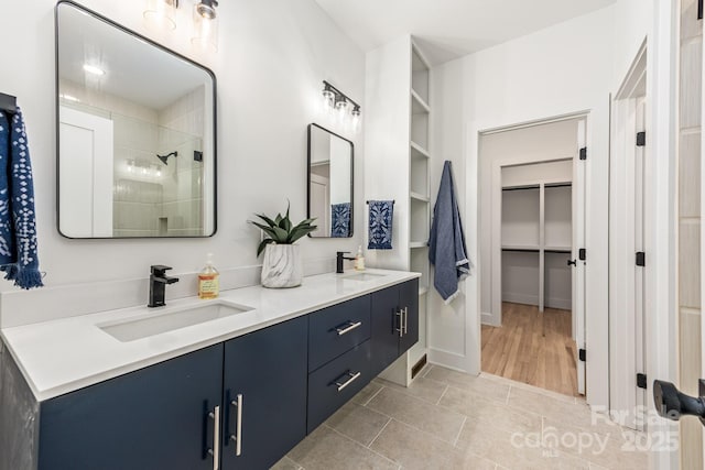 1847 Vinton St, Charlotte, NC 28216 - bathroom featuring a walk in closet, a tile shower, a sink, and double vanity
