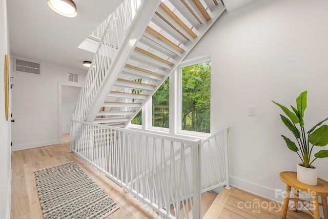 1847 Vinton St, Charlotte, NC 28216 - staircase featuring baseboards, wood finished floors, and visible vents