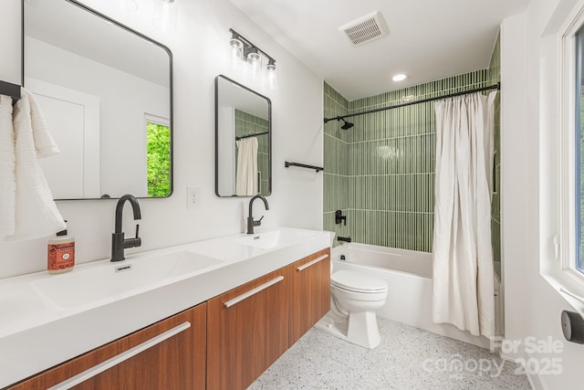 1847 Vinton St, Charlotte, NC 28216 - bathroom with speckled floor, visible vents, toilet, a sink, and shower / bath combo with shower curtain
