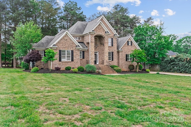 view of front of home featuring brick siding and a front lawn