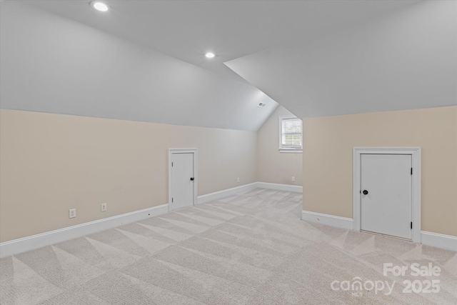 additional living space with lofted ceiling, light carpet, recessed lighting, and baseboards