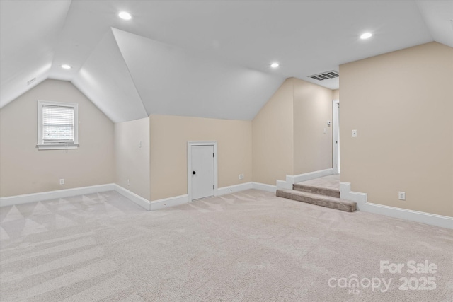 bonus room with lofted ceiling, visible vents, recessed lighting, and light carpet