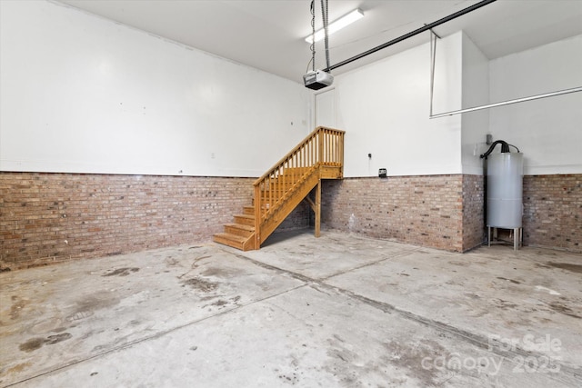 garage with a garage door opener and water heater