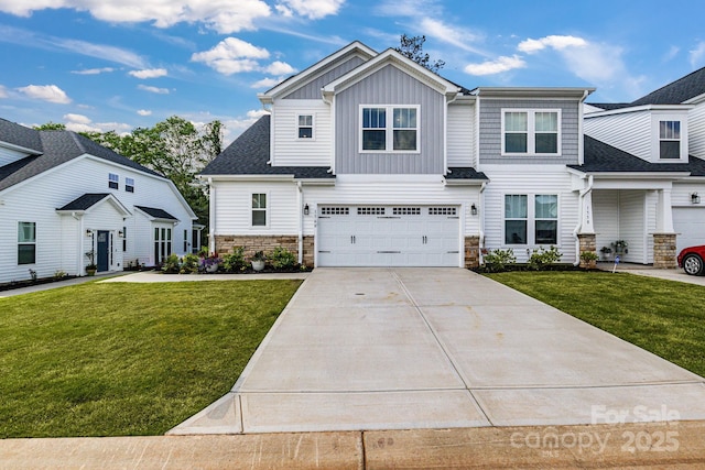 view of front of home featuring a garage, driveway, a front lawn, and stone siding