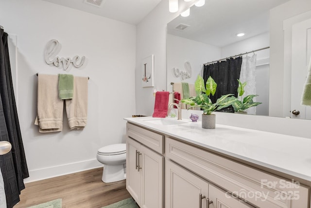 full bathroom featuring vanity, toilet, baseboards, curtained shower, and wood finished floors