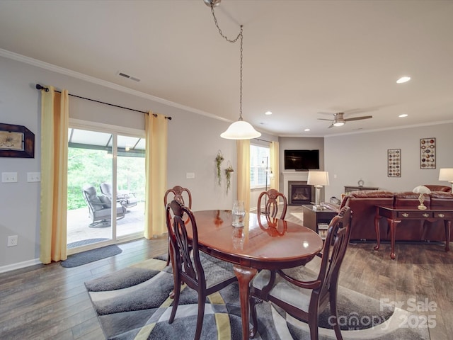dining area with crown molding, visible vents, and a healthy amount of sunlight