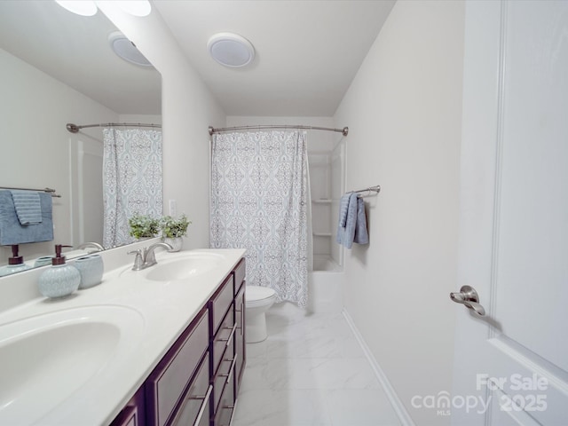 full bath featuring double vanity, shower / tub combo, a sink, toilet, and marble finish floor