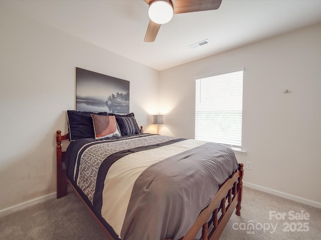 carpeted bedroom with ceiling fan, visible vents, and baseboards