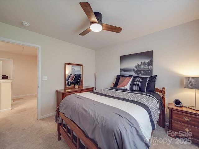 bedroom with light colored carpet, baseboards, and ceiling fan