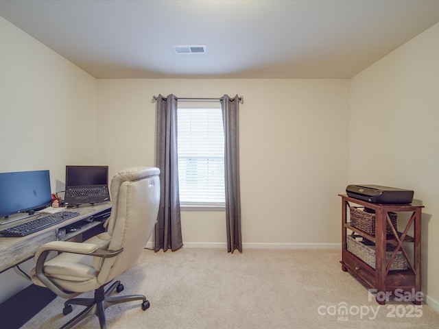home office with baseboards, light colored carpet, and visible vents