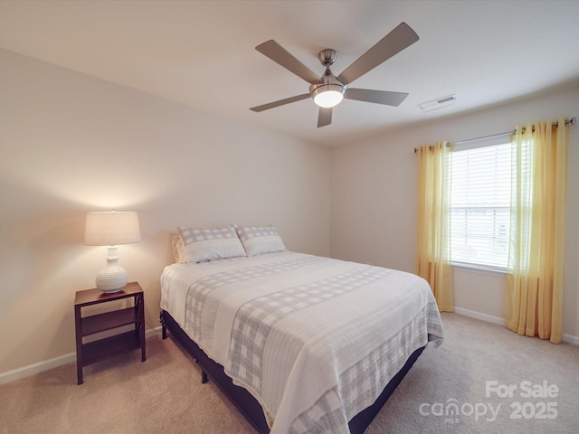 bedroom with baseboards, visible vents, a ceiling fan, and light colored carpet