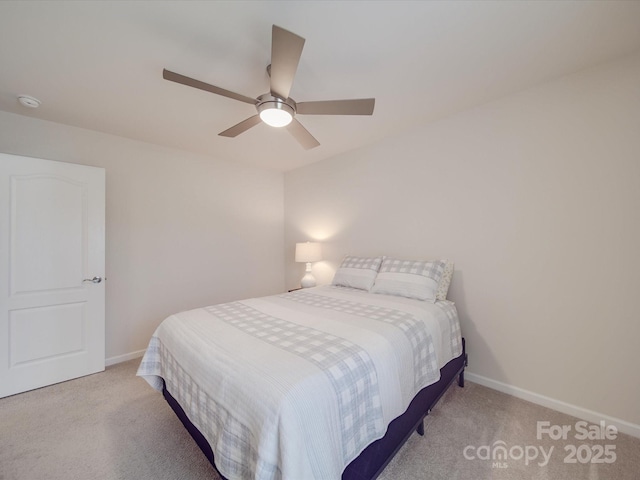 bedroom featuring baseboards, ceiling fan, and light carpet