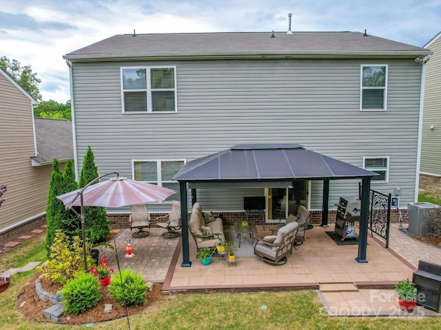 rear view of property with a patio, a gazebo, cooling unit, and outdoor lounge area