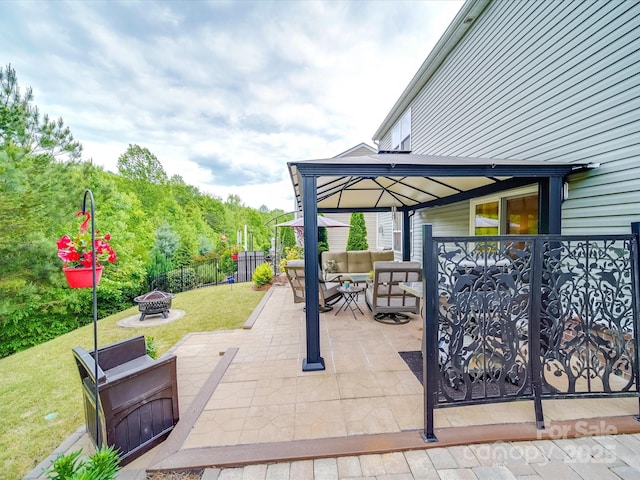 view of patio featuring an outdoor living space with a fire pit and fence
