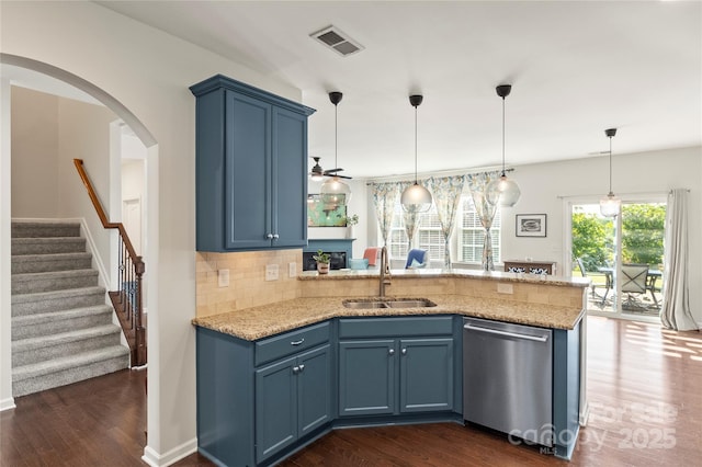 kitchen featuring dark wood-style flooring, a sink, dishwasher, a peninsula, and visible vents