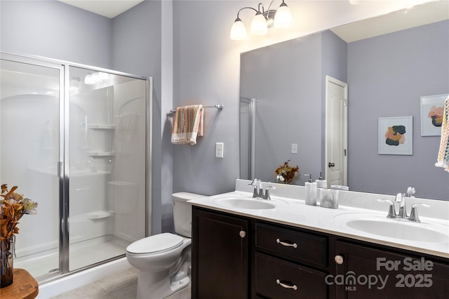 bathroom with a sink, tile patterned flooring, a stall shower, and toilet