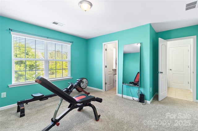 exercise room featuring carpet flooring, baseboards, and visible vents