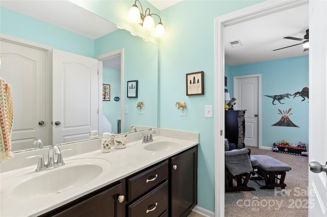 full bath with visible vents, a sink, a ceiling fan, and double vanity