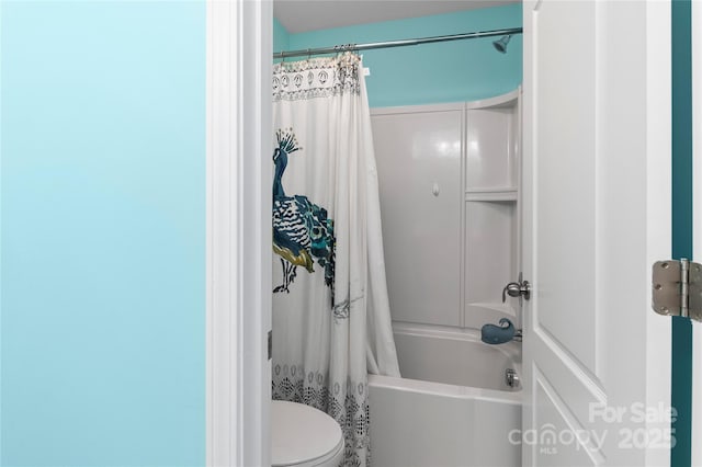 full bathroom with shower / bath combo with shower curtain and toilet