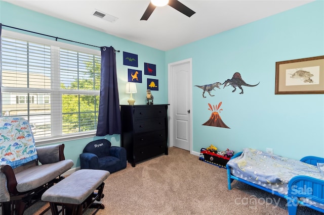 bedroom with carpet flooring, ceiling fan, visible vents, and multiple windows