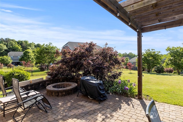 view of patio with fence, a grill, and an outdoor fire pit