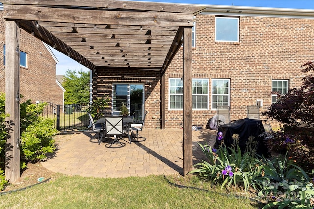 view of patio featuring a pergola, fence, and a grill