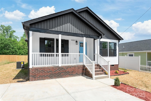 640 Central Dr NW, Concord, NC 28027 - bungalow-style house with board and batten siding, fence, and covered porch