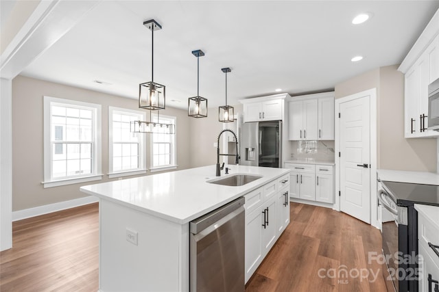 640 Central Dr NW, Concord, NC 28027 - kitchen featuring stainless steel appliances, recessed lighting, a sink, and wood finished floors