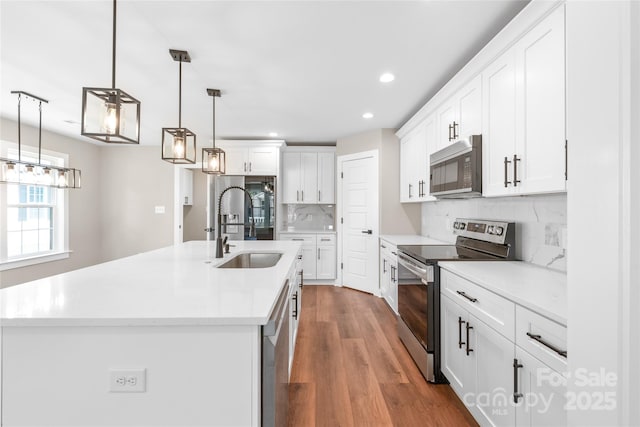 640 Central Dr NW, Concord, NC 28027 - kitchen featuring recessed lighting, white cabinetry, a sink, appliances with stainless steel finishes, and backsplash